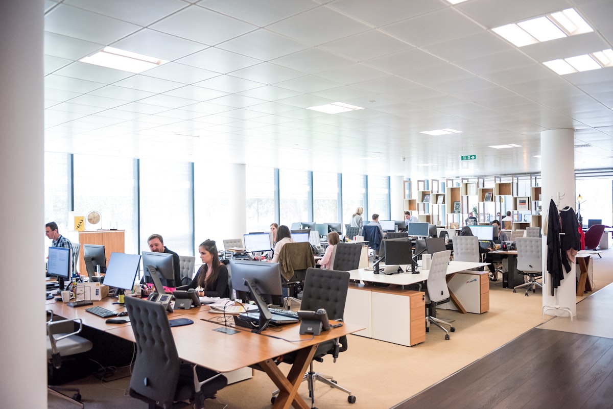 An open office floor with people working at rows of desks