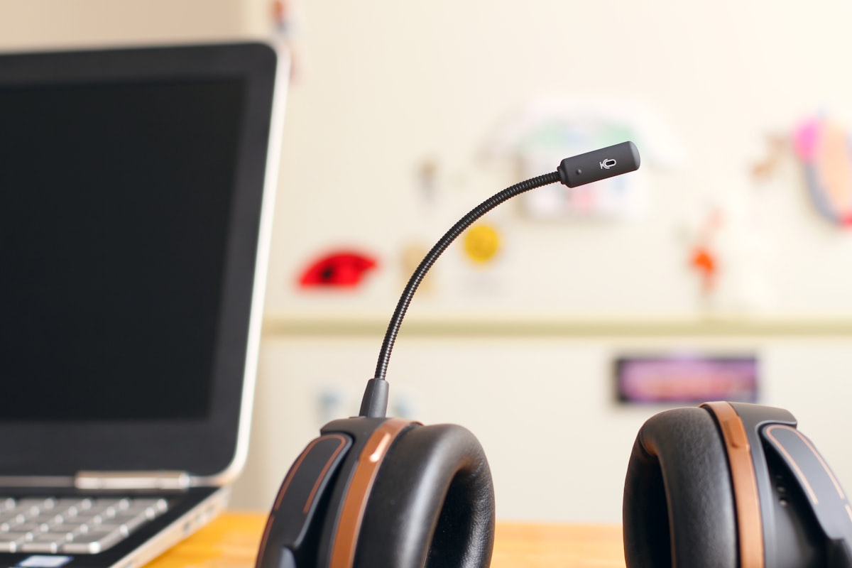 A telephone headset resting beside a laptop